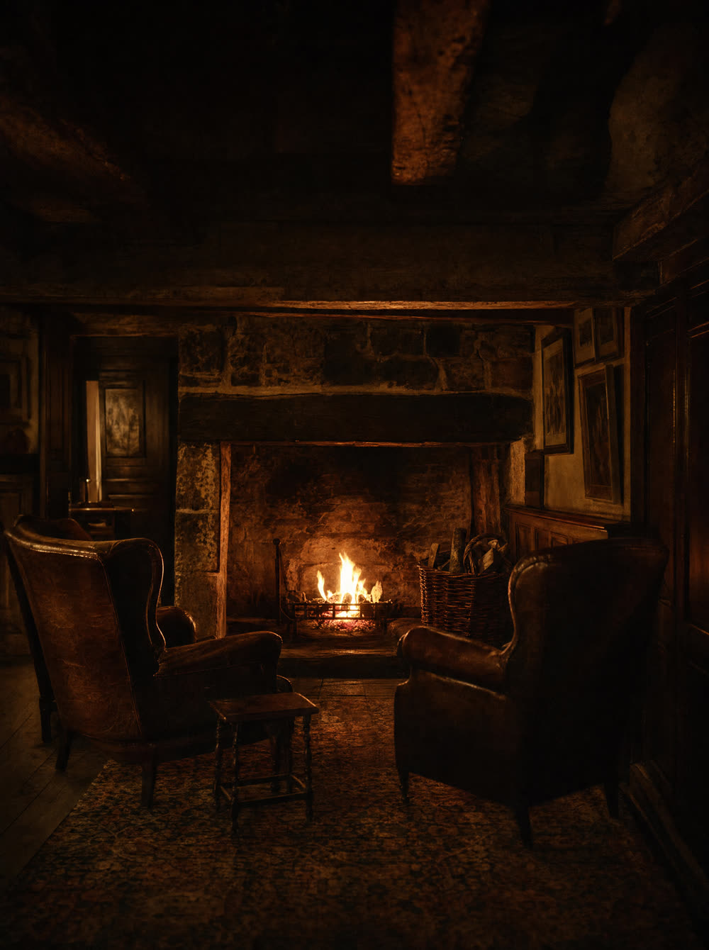 A log fire in the stone fireplace of a hotel lounge, two leather armchairs turned towards it